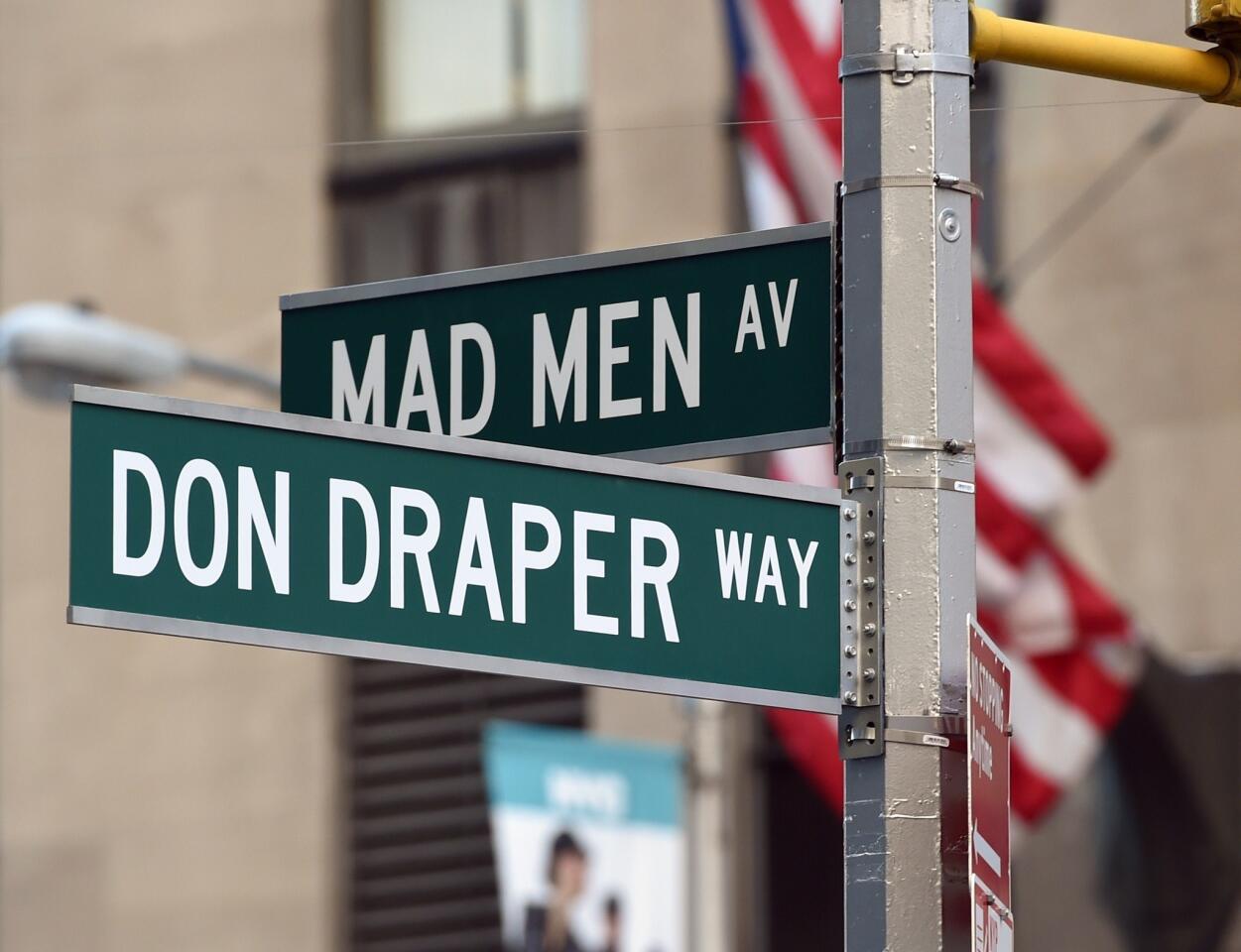 A street sign on 6th Avenue marks the spot as AMC officially unveils a commemorative 'Mad Men" sculpture of public art in front of the Time & Life Building home to the fictional Cooper & Partners offices in New York .