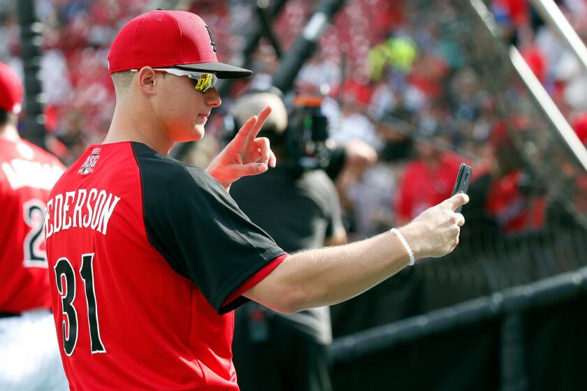 Dodgers All-Star outfielder Joc Pederson takes a selfie on the field during the Gatorade All-Star workout Monday.