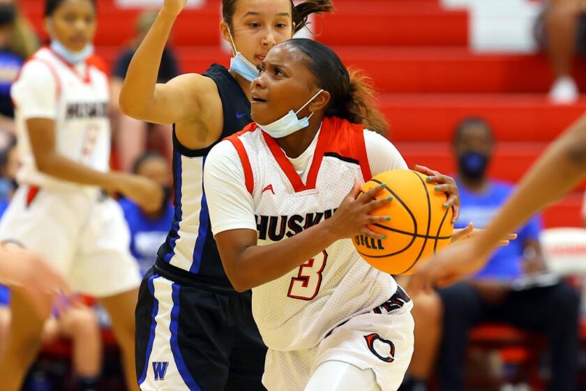 Londynn Jones of Corona Centennial drives against Windward on Monday night.