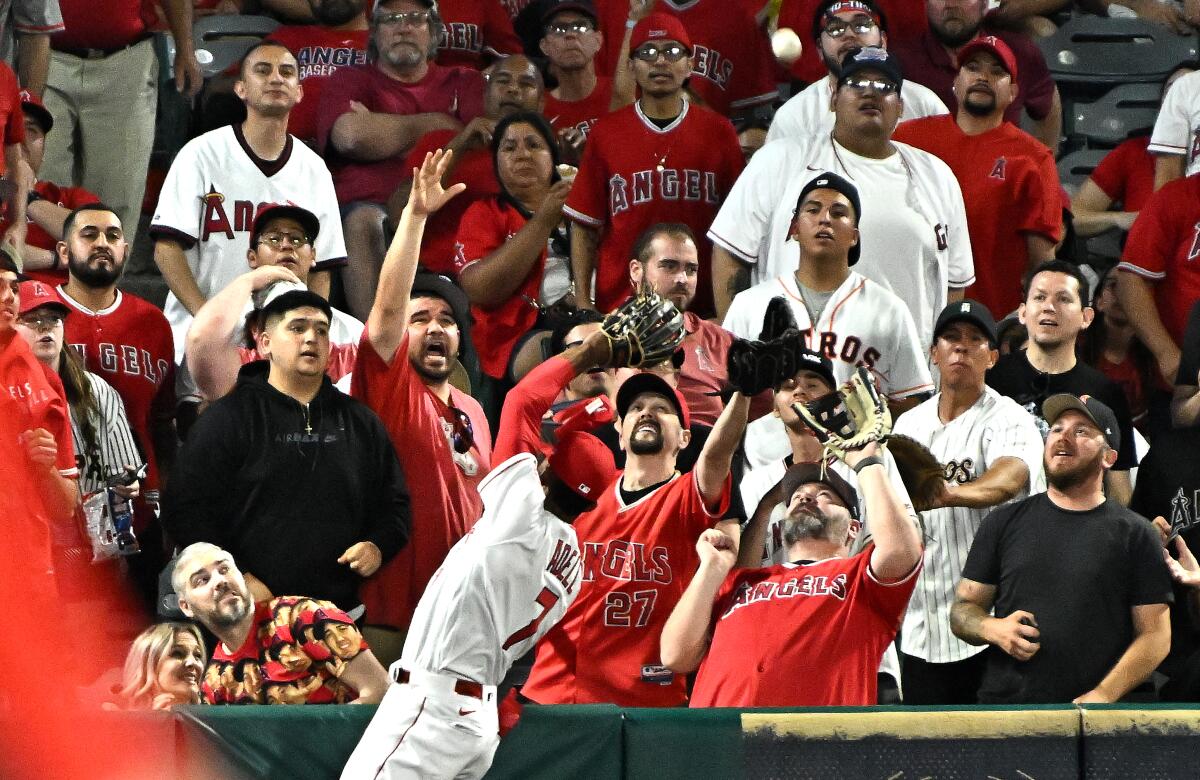 Angels left fielder Jo Adell can't make the catch on a solo home run hit by Houston's Alex Bregman.