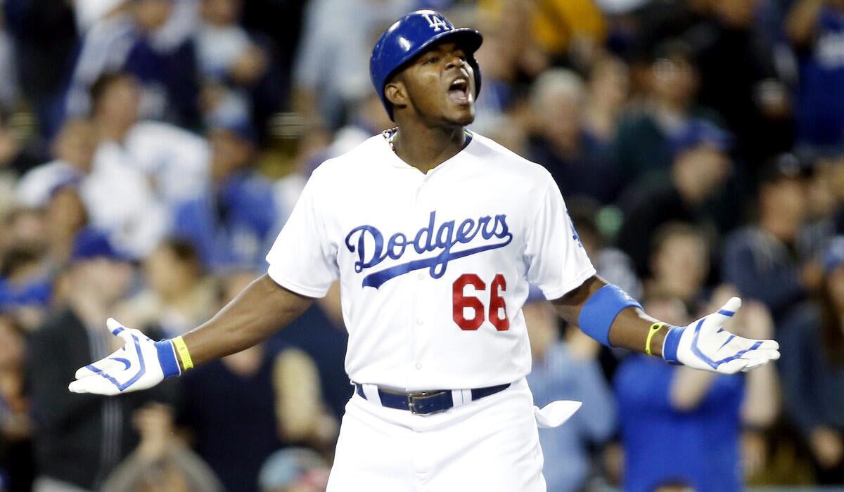 Dodgers right fielder Yasiel Puig exchanges words Giants starting pitcher Madison Bumgarner (not pictured) as Puig runs down the third-base line after hitting a solo home run in the sixth inning Friday night.