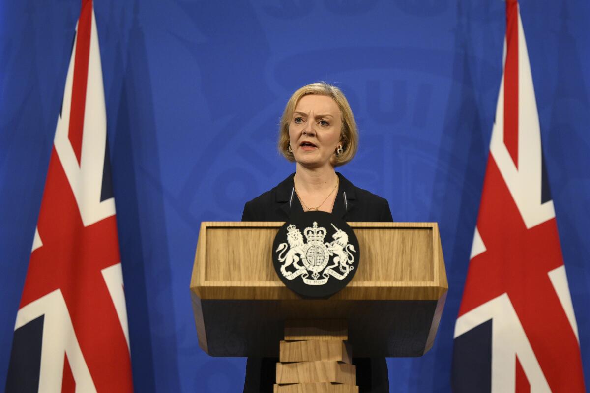 British Prime Minister Liz Truss speaking from lectern