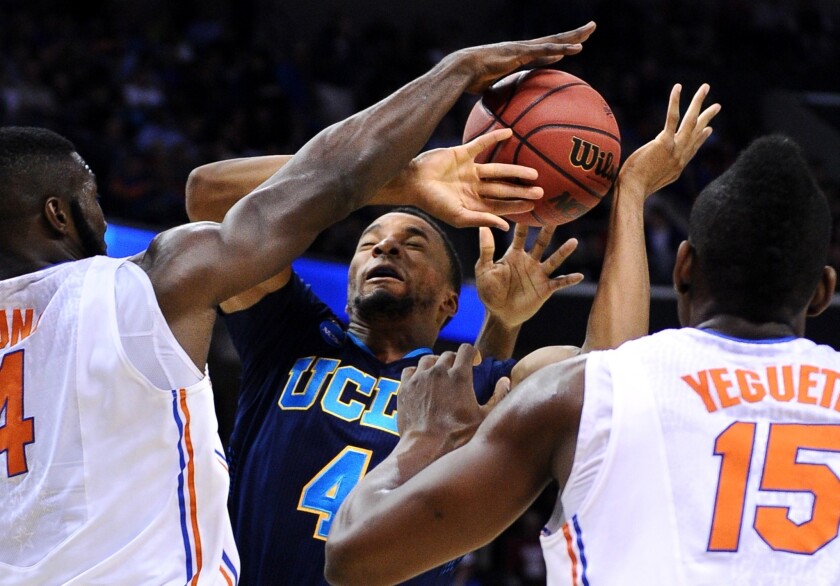 Bruins guard Norman Powell is fouled by Gators forward Patric Young on a shot in their NCAA tournament game.