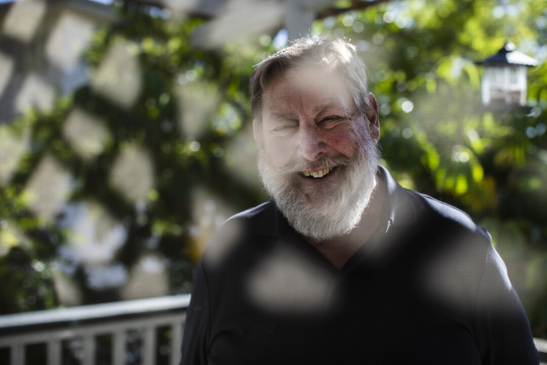 A man smiles at the camera.