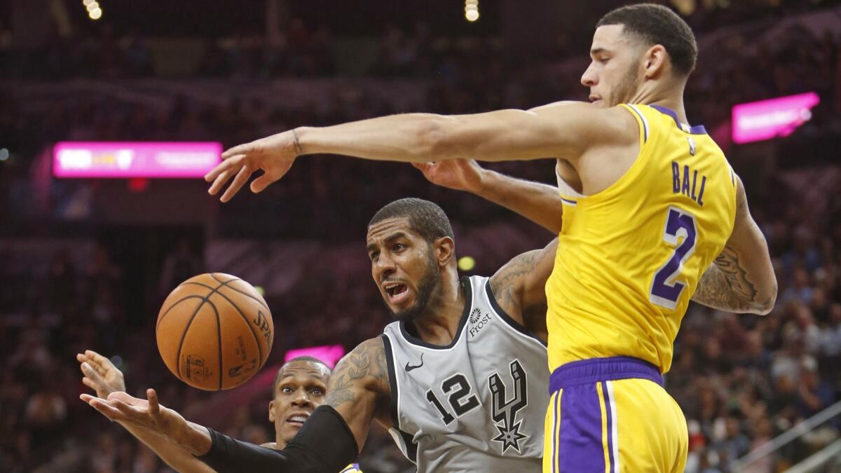 Lakers guard Lonzo Ball battles Spurs forward LaMarcus Aldridge for the ball during their game Oct. 27