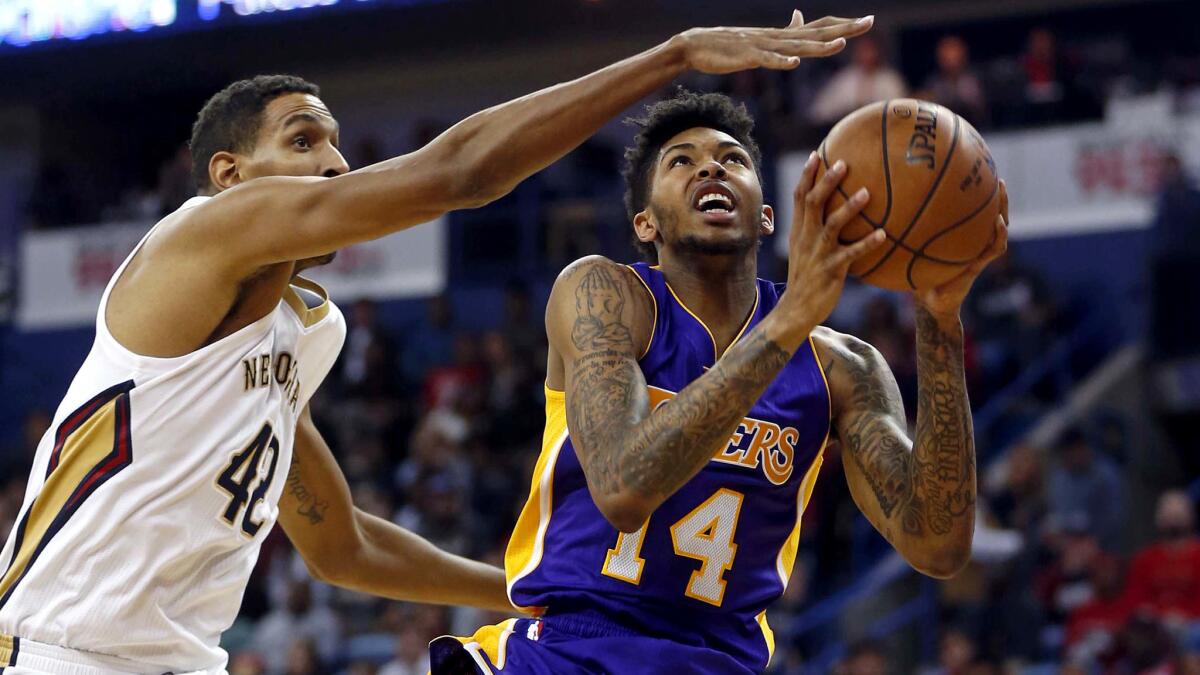 Lakers forward Brandon Ingram drives to the basket against Pelicans center Alexis Ajinca during the first half Saturday.