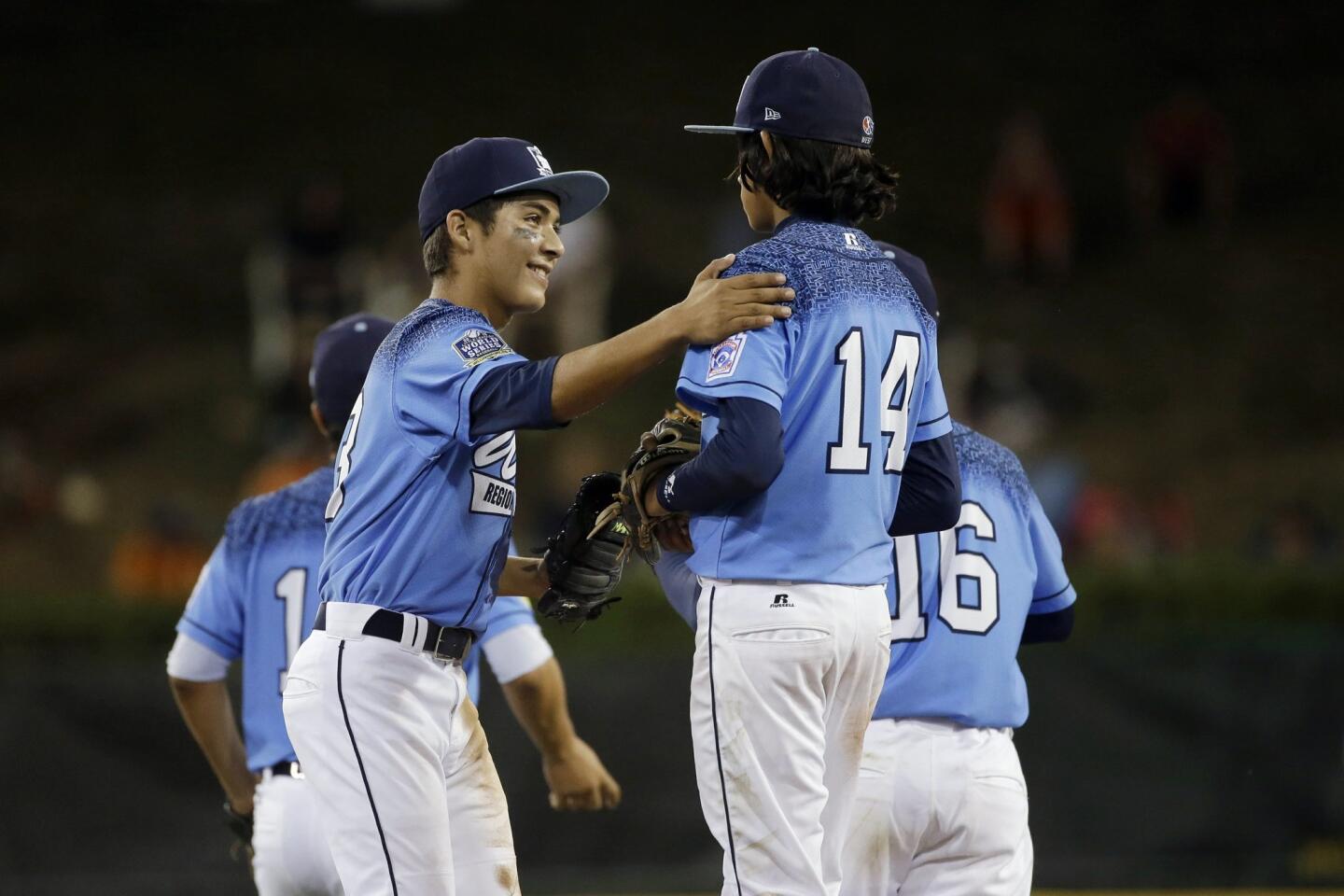 Sweetwater Valley's Antonio Andrade, left, celebrates with Nate Nankil after a strikeout during the sixth inning of a U.S. elimination baseball game against Bowling Green, Ky.