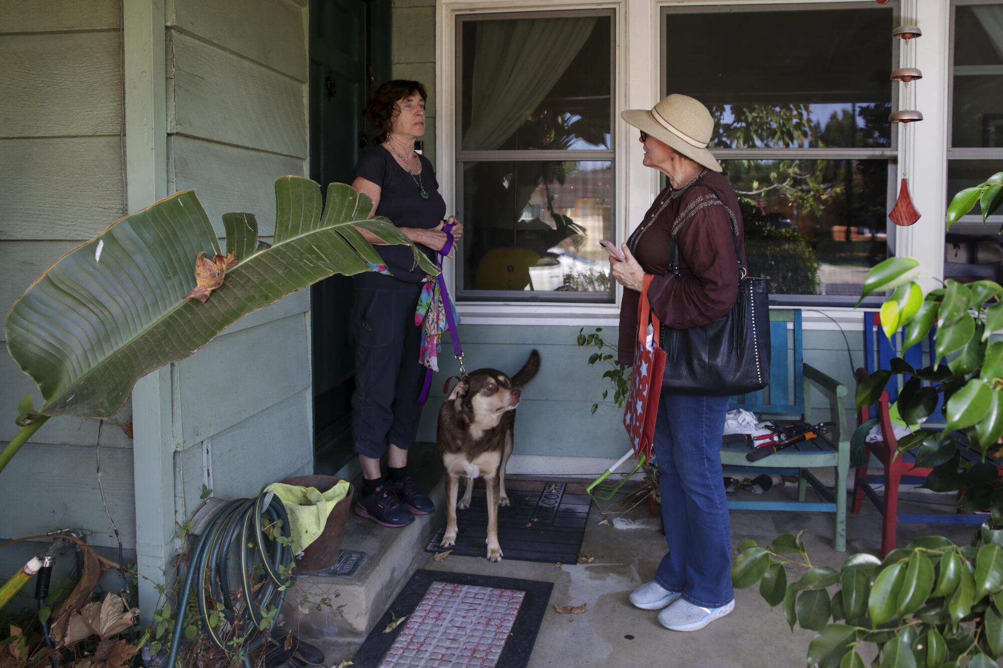Volunteer Trish Dexter, right, talks to a resident 
