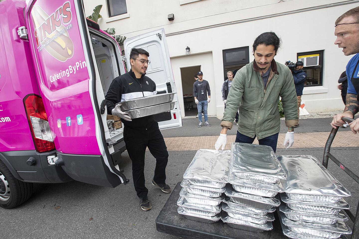 Pink's Hot Dogs workers deliver donated food to the Dream Center in L.A.