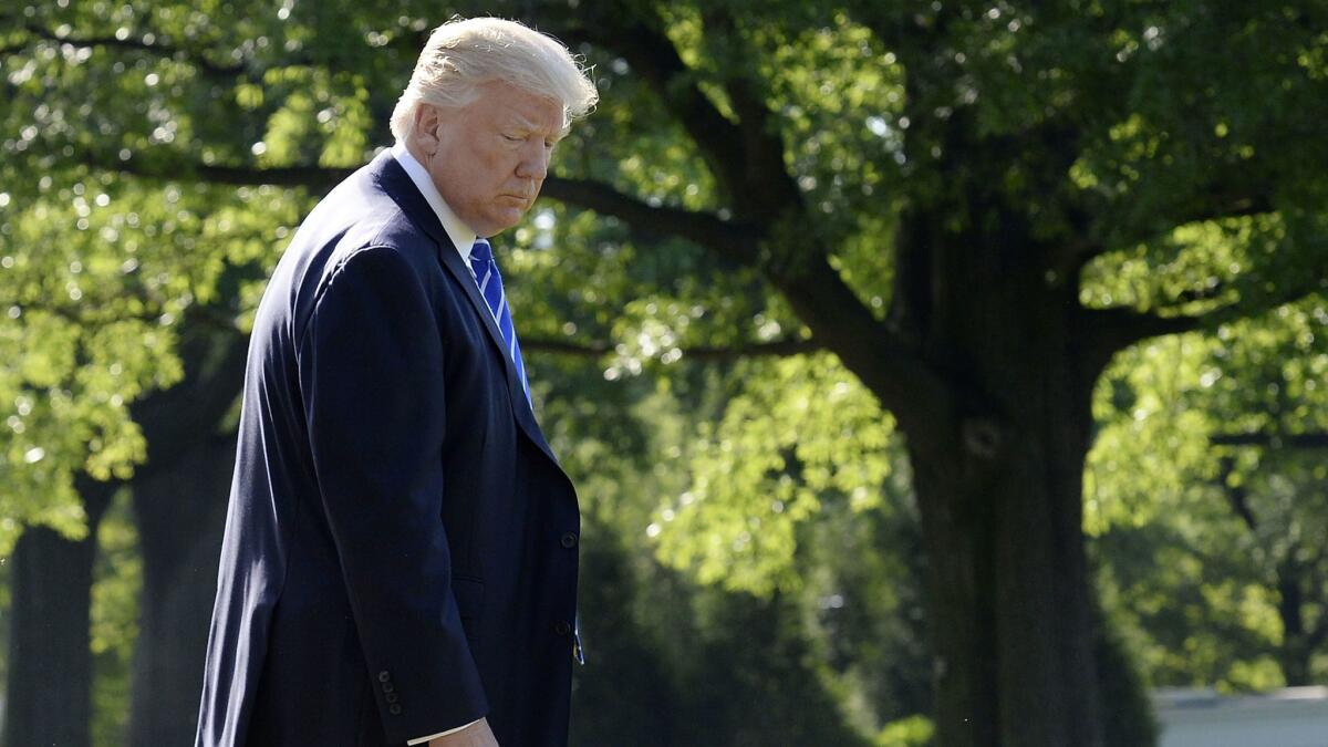 U.S. President Donald Trump waves as he walks towards Marine One while departing the White House on May 17, 2017 in Washington, D.C.