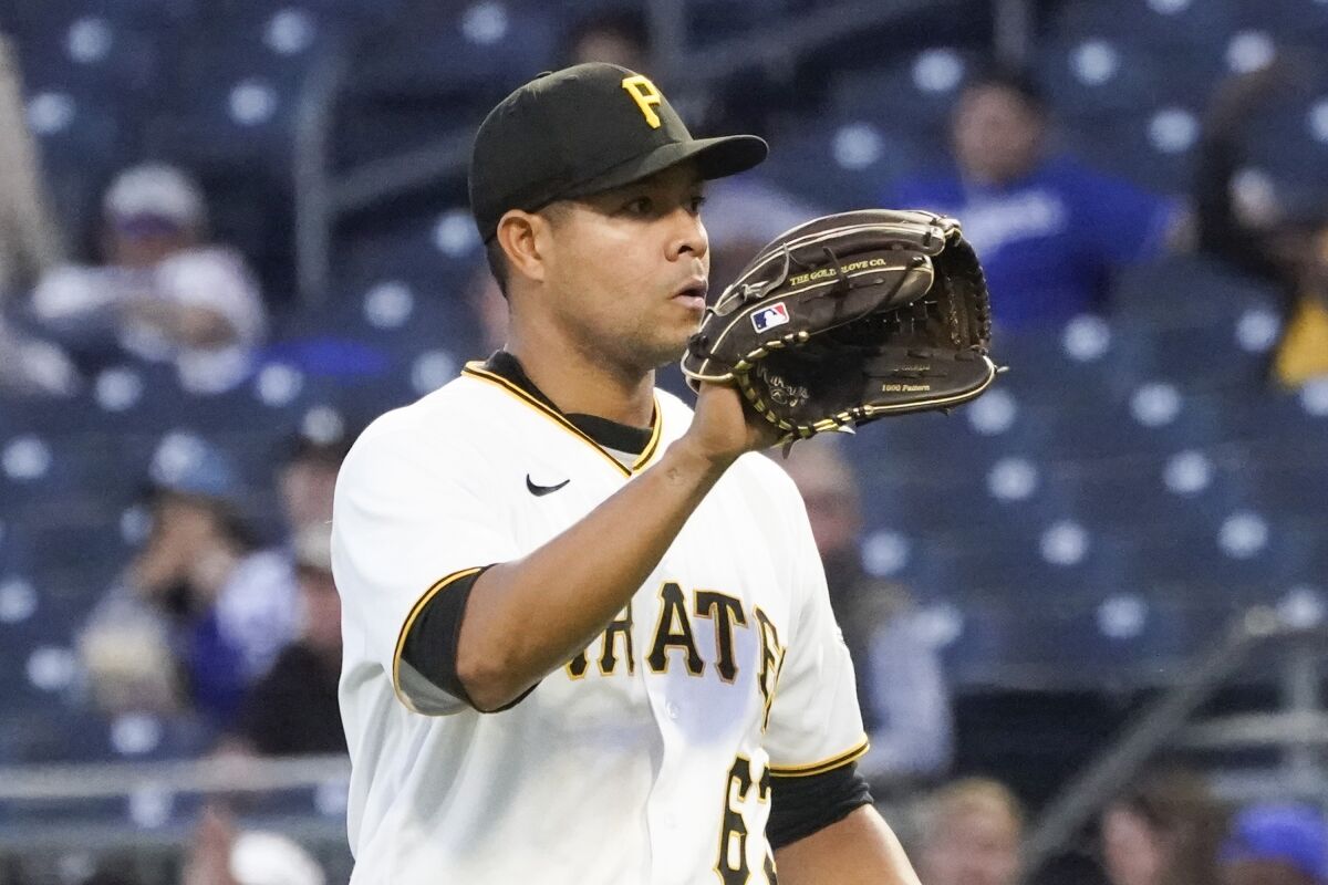 Pittsburgh Pirates starting pitcher Jose Quintana gets a new ball as he pitches against the Los Angeles Dodgers during the sixth inning of a baseball game, Monday, May 9, 2022, in Pittsburgh. (AP Photo/Keith Srakocic)