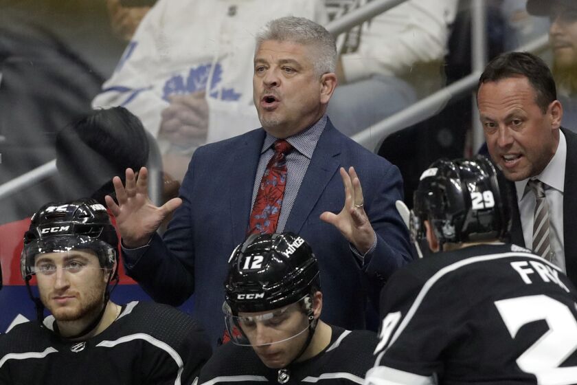 Los Angeles Kings head coach Todd McLellan and assistant coach Marco Sturm instruct from the bench.