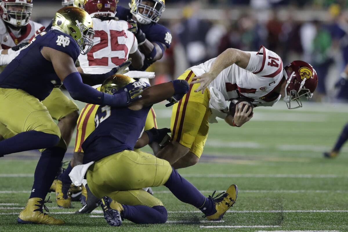 USC quarterback Sam Darnold is sacked by Notre Dame defensive lineman Khalid Kareem during the first half on Saturday.