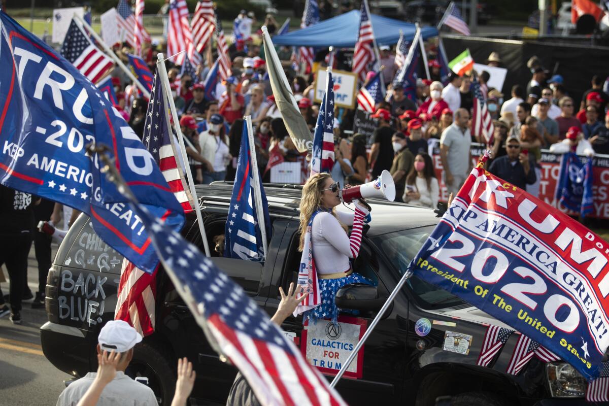A large crowd chants "four more years" during a Pro Trump rally on Santa America Blvd and Beverly Blvd in Beverly Hills 