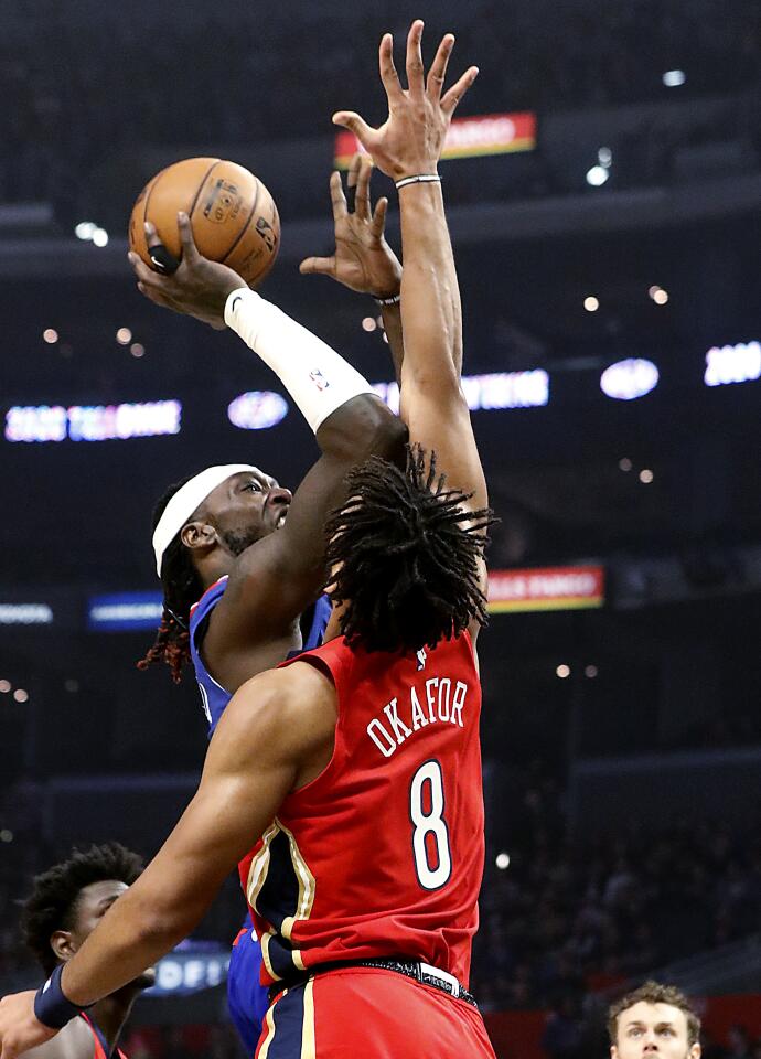Clippers forward Montrezl Harrell is fouled by New Orleans Pelicans center Jahlil Okafor.