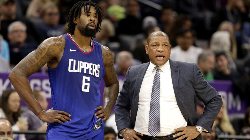 DeAndre Jordan talks with Clippers coach Doc Rivers.