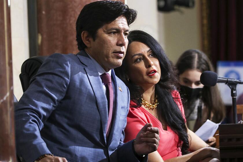 L.A. Councilman Kevin de Leon Council President Nury Martinez confer at a meeting on Oct. 4, 2022.