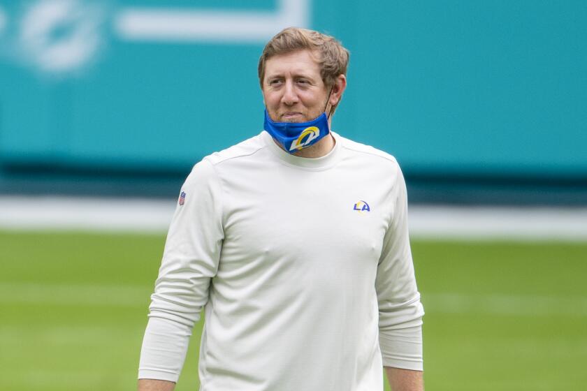 Los Angeles Rams assistant quarterbacks coach Liam Coen smiles on the field before the Rams.