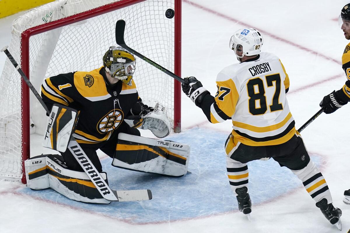 Pittsburgh Penguins center Sidney Crosby (87) watches as his shot hits the post against Boston Bruins goaltender Jeremy Swayman (1) during the third period of an NHL hockey game, Tuesday, Feb. 8, 2022. Crosby scored his 499th NHL career goal during the second period. (AP Photo/Charles Krupa)