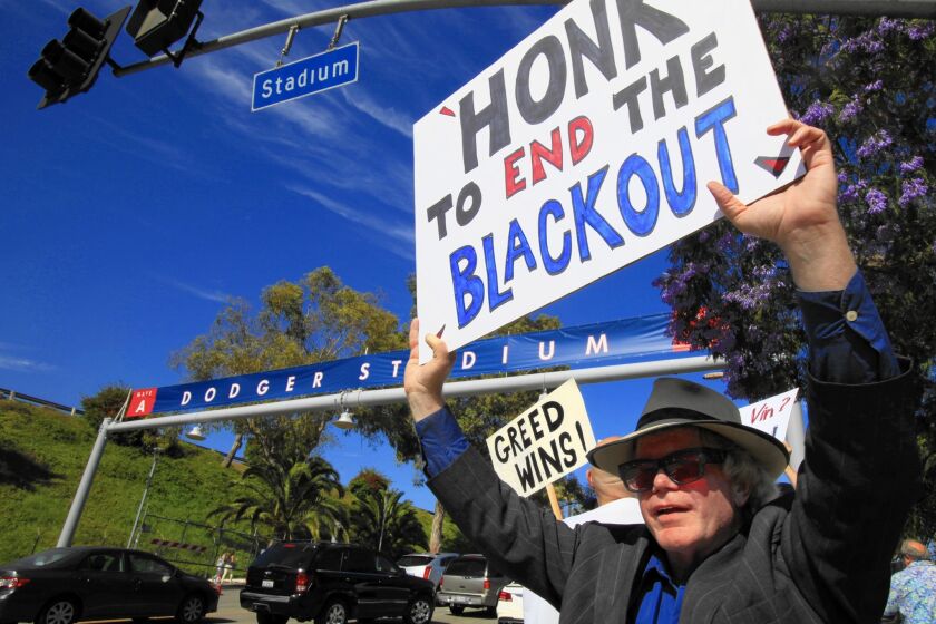 Bill Peterson, 54, of Los Angeles, and about 25 others protest protest the TV blackout outside Dodger Stadium last June.