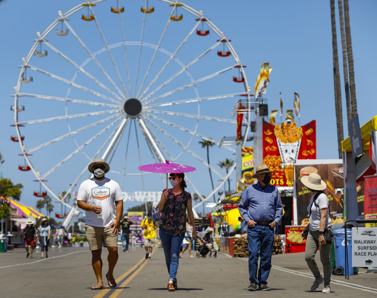 Fair goers take to the midway on opening day for HomeGrown Fun, a scaled-down version of the San Diego County Fair