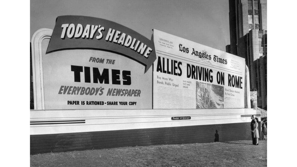 A billboard shows an enlarged version of the L.A. Times front page with the headline "ALLIES DRIVING ON ROME." 