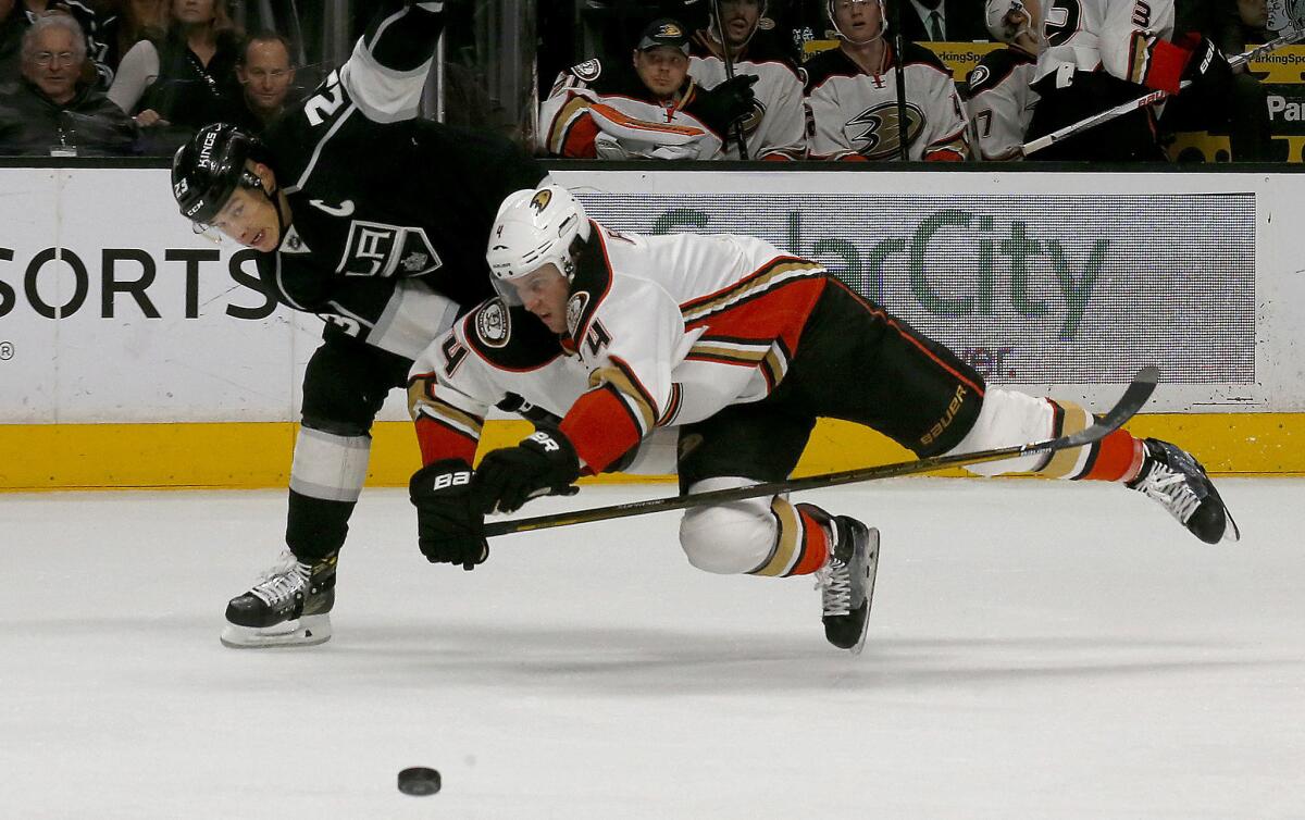 Kings winger Dustin brown and Ducks defenseman Cam Fowler fight for control of the puck on April 7.