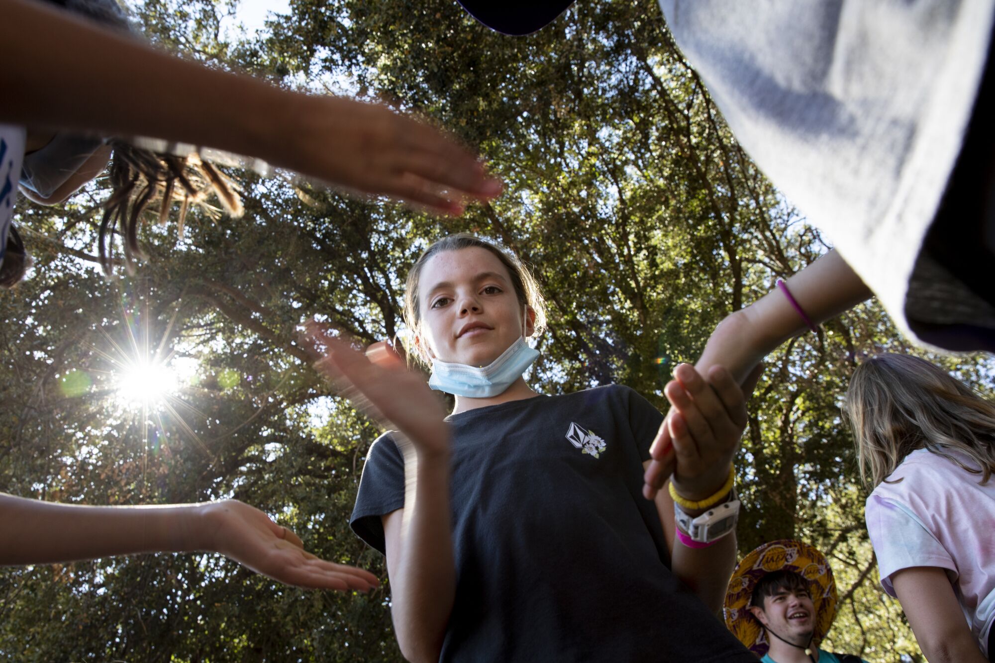 Sixth-graders Rachel Stein, left, Layla Smith and Taylor Duralde play a game called "Down by the banks" at  Camp Marston.