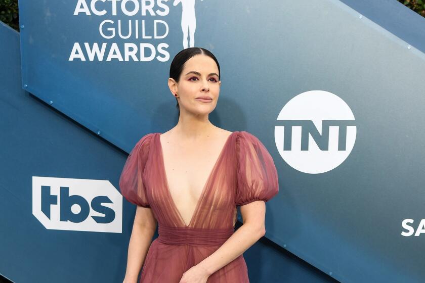 Emily Hampshire arrives at the SAG Awards in a long ruffled gown