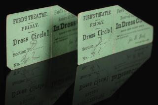 In this photo provided by Boston-based RR Auction house, rare front-row balcony tickets to Ford's Theatre on April 14, 1865 rest on a reflective surface. The tickets, dated when President Abraham Lincoln was assassinated by John Wilkes Booth, were sold at auction for $262,500, Saturday, Sept. 23, 2023, according to RR Auction. (Nikki Brickett/RR Auction via AP)