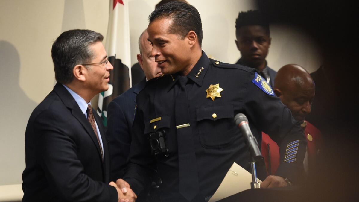 California Atty. Gen. Xavier Becerra, left, and Sacramento Police Chief Daniel Hahn shake hands after they announced last year that the state would review the shooting death of Stephon Clark.