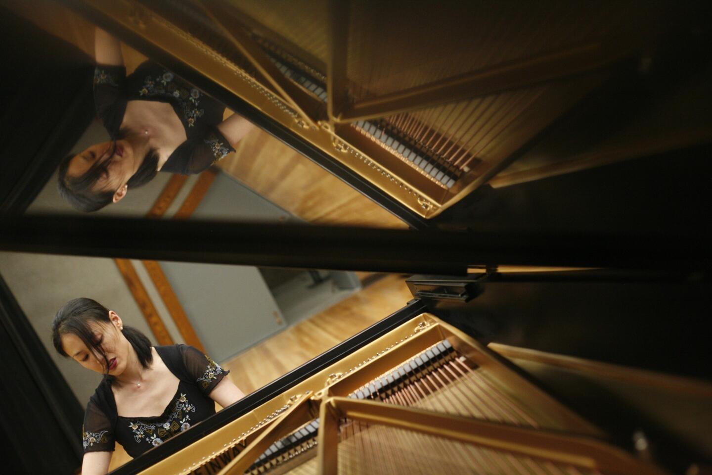 UCLA doctoral candidate Lana Chae plays Sapphire at UCLA's Royce Hall. After Sapphire's arrival last December, she volunteered to spend hundreds of hours breaking in the piano. When she played it for the first time, she wept. "She's so responsive," Chae said.