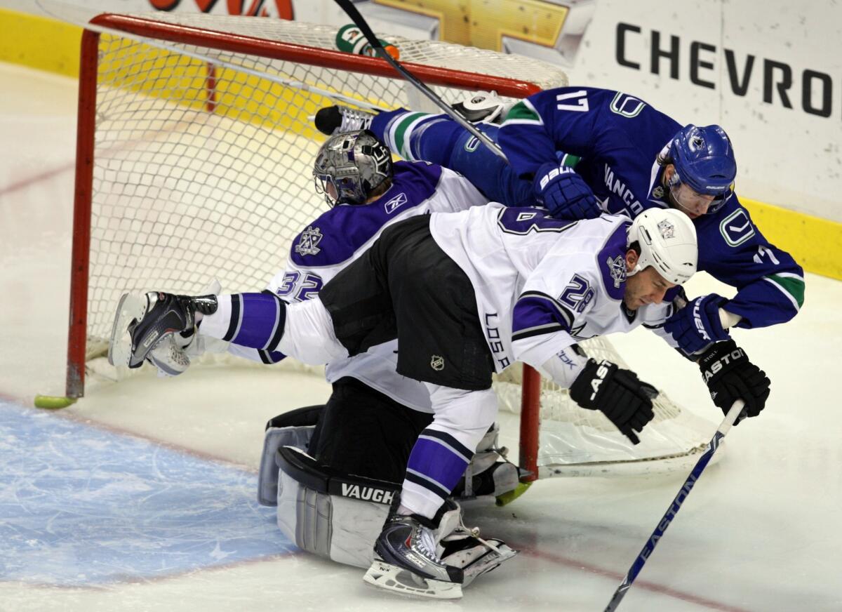 Vancouver's Ryan Kesler crashes into Kings goalie Jonathan Quick and Jarret Stoll in a game on Dec. 14, 2009.