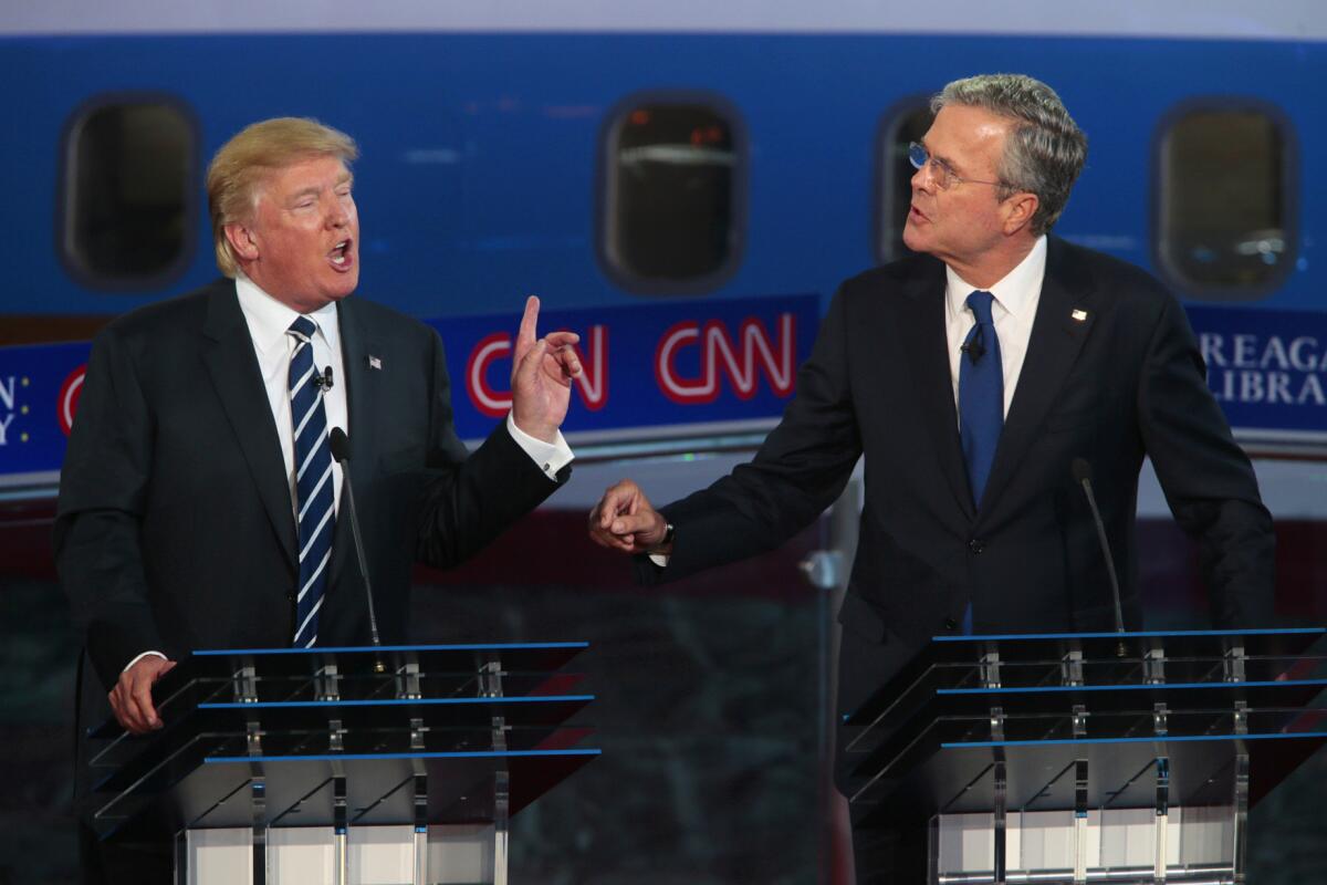 Donald Trump, left and Jeb Bush spar early in the debate.