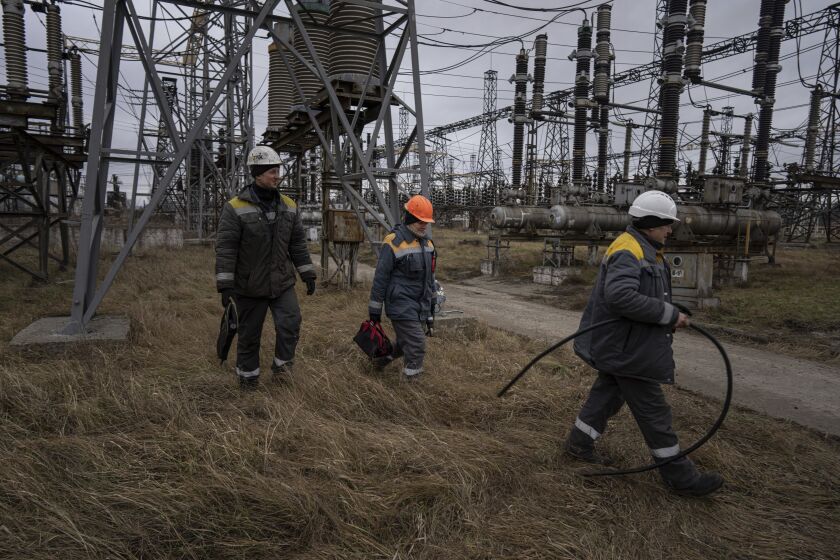 Power plant workers arrive to repair damages after a Russian attack in central Ukraine, Thursday, Jan. 5, 2023. When Ukraine was at peace, its energy workers were largely unheralded. War made them heroes. They're proving to be Ukraine's line of defense against repeated Russian missile and drone strikes targeting the energy grid and inflicting the misery of blackouts in winter. (AP Photo/Evgeniy Maloletka)