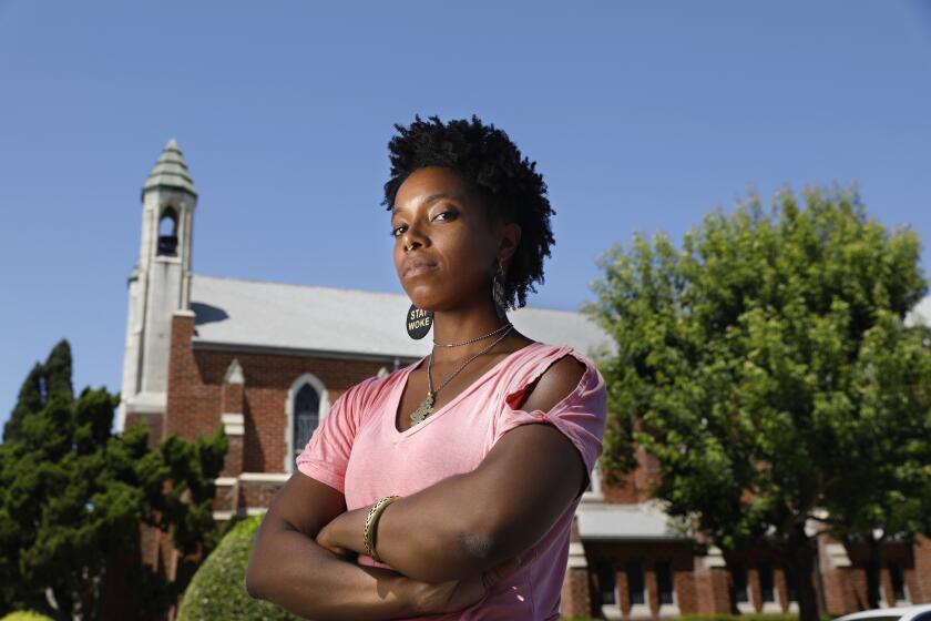 North Hollywood, California-July 10, 2020--Actress and stuntwoman Alex Marshall-Brown in front of St. Paul's First Lutheran Church, and the tree where she was sitting and church members told her to leave the property. Portrait taken on July 10, 2020. (Carolyn Cole/Los Angeles Times)