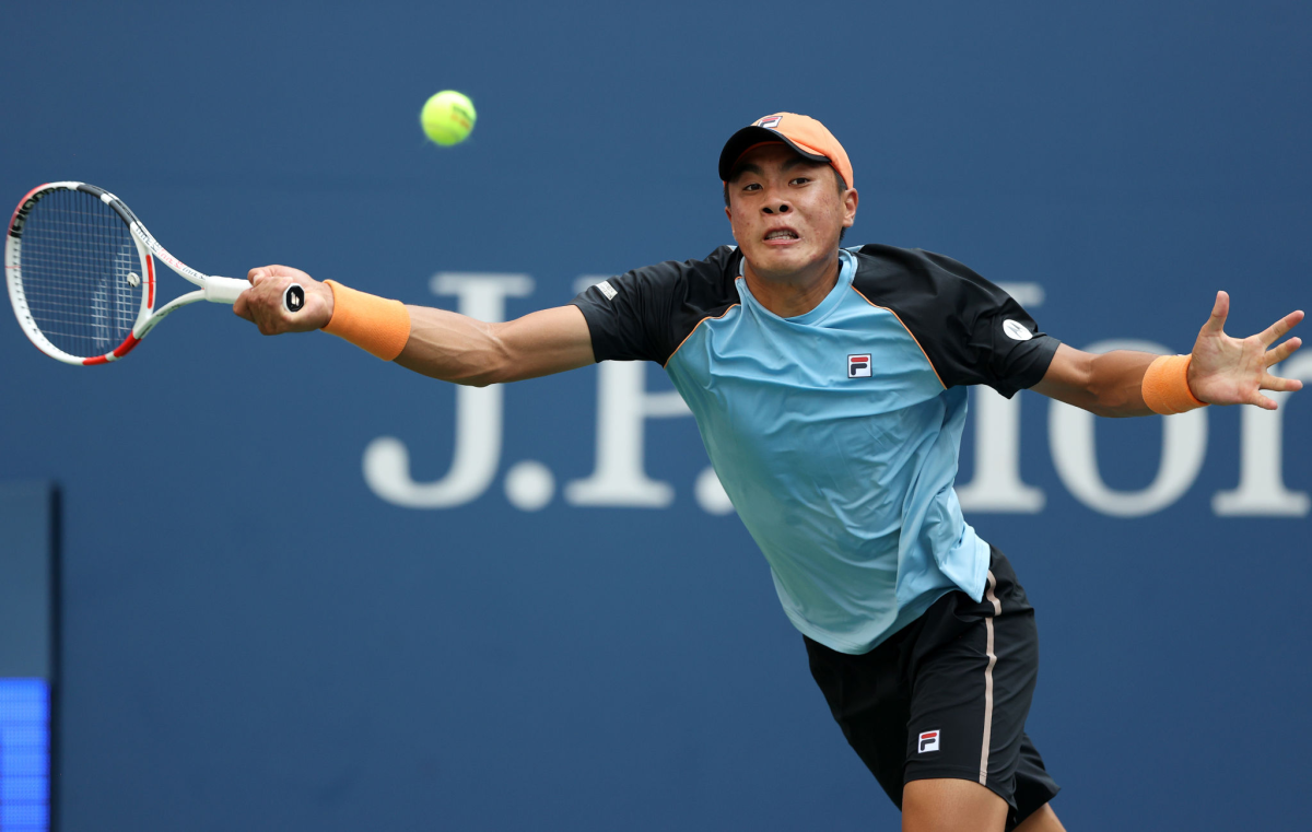 Brandon Nakashima hits a return during his victory over John Isner in the first round of the U.S. Open on Monday.
