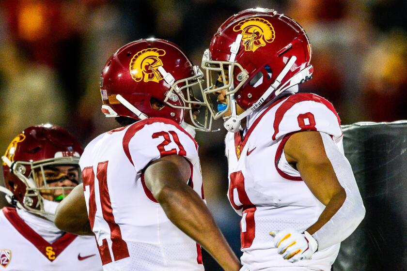 BOULDER, CO - OCTOBER 25: Amon-Ra St. Brown #8 of the USC Trojans is congratulated by Tyler Vaughns #21 and Drake London #15 after a first quarter touchdown against the Colorado Buffaloes at Folsom Field on October 25, 2019 in Boulder, Colorado. (Photo by Dustin Bradford/Getty Images)
