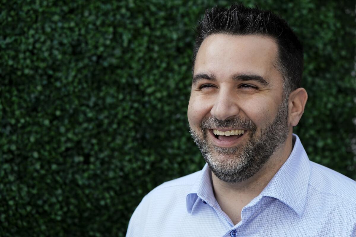 Atlanta Braves general manager Alex Anthopoulos talks with reporters during Major League Baseball's general manager meetings, Wednesday, Nov. 10, 2021, in Carlsbad, Calif. (AP Photo/Gregory Bull)