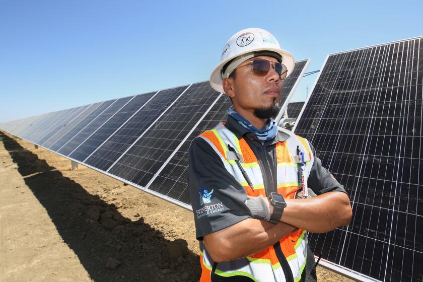 LEMOORE CA JUNE 24, 2021 - George Fernandez of Swinerton works on the construction site of Westlands Solar Park, which when completed will be one of the largest solar farms in the nation, located in Lemoore, Calif., Thursday, June 24, 2021. (Gary Kazanjian/For The Times)