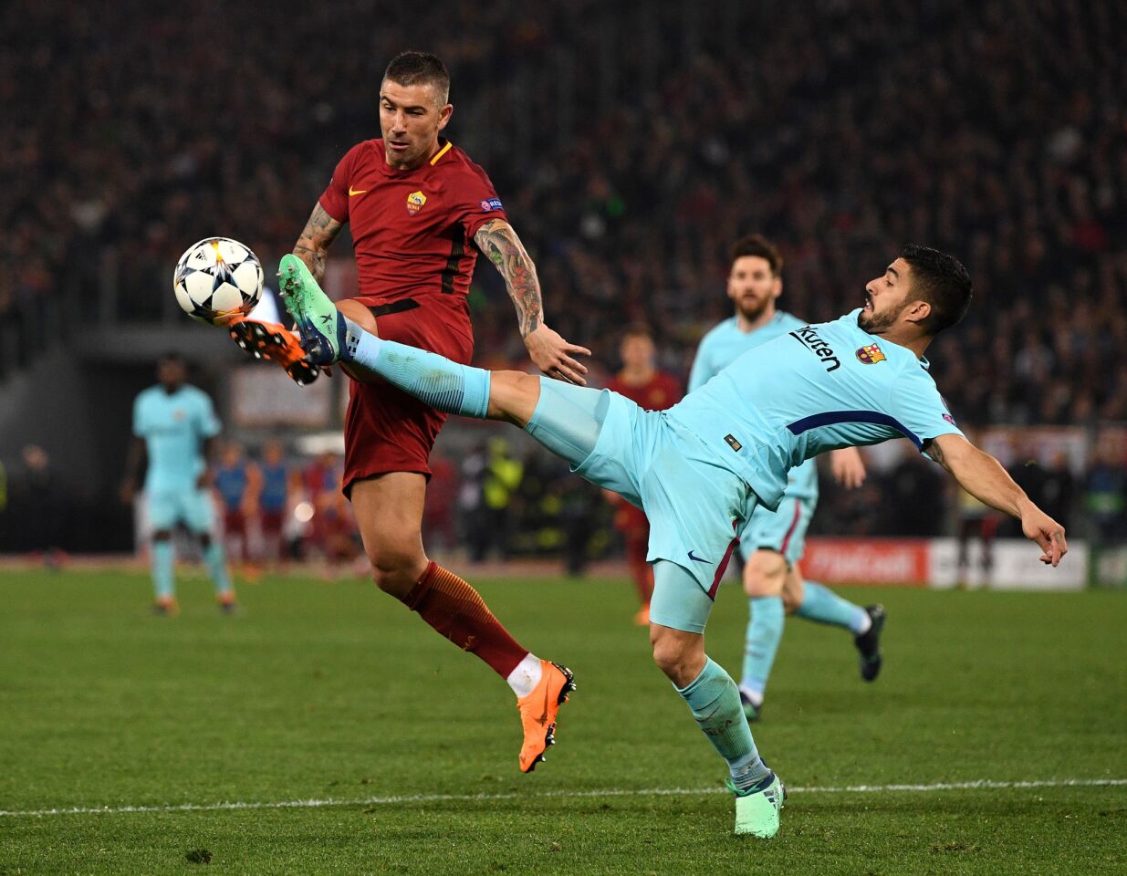 ROME, ITALY - APRIL 10: Aleksandar Kolarov of AS Roma is challenged by Luis Suarez of Barcelona UEFA Champions League Quarter Final Second Leg match between AS Roma and FC Barcelona at Stadio Olimpico on April 10, 2018 in Rome, Italy.