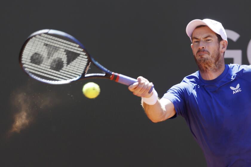 Andy Murray, of Great Britain, returns the ball to Yannick Hanfmann, of Germany, during the men's singles first round of the ATP 250 Geneva Open tournament in Geneva, Switzerland, Tuesday, May 21, 2024. (Salvatore Di Nolfi/Keystone via AP)