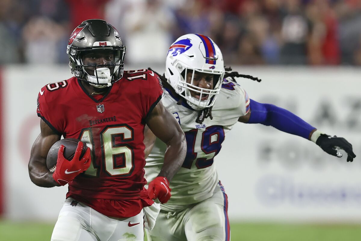 Tampa Bay Buccaneers wide receiver Breshad Perriman (16) outruns Buffalo Bills linebacker Tremaine Edmunds (49) on a 55-yard touchdown reception during overtime of an NFL football game Sunday, Dec. 12, 2021, in Tampa, Fla. (AP Photo/Mark LoMoglio)