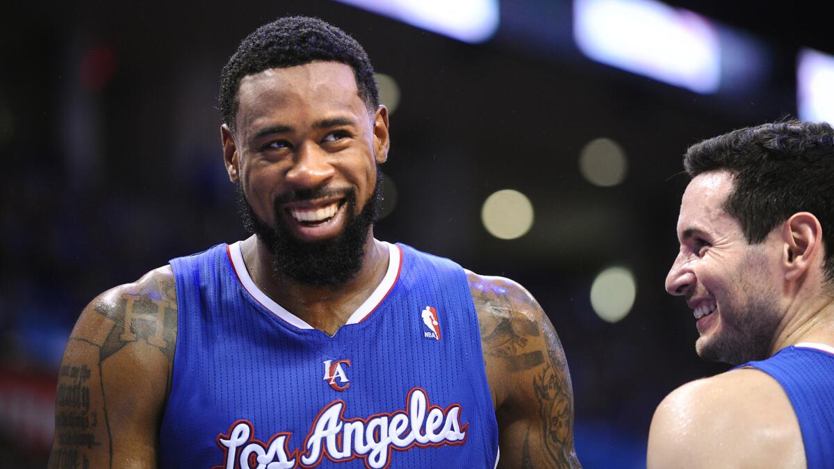 Clippers center DeAndre Jordan, left, shares a laugh with teammate J.J. Redick during a playoff game against the Oklahoma City Thunder in May 2014.