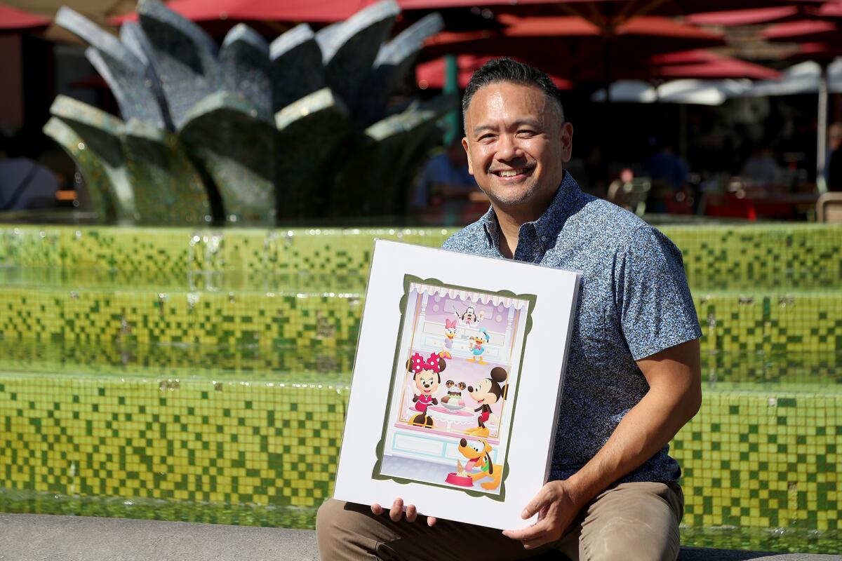 Artist Jerrod Maruyama, 50, of Irvine, with one of his illustrations at Downtown Disney in Anaheim. 