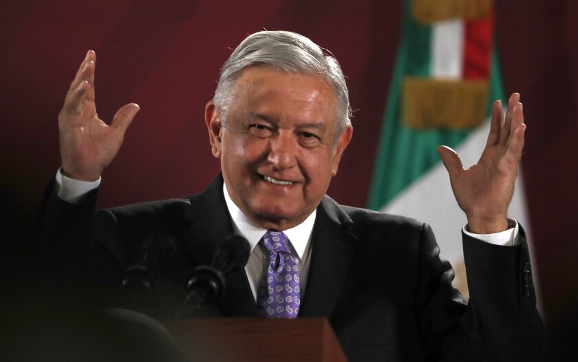 FILE In this Nov. 13, 2019 file photo, Mexican President Andres Manuel Lopez Obrador smiles during his daily morning news conference at the National Palace in Mexico City. The Mexican president closed out 2019 with a Dec. 31 video message in which he recounted his administration's successes in its first year, including rooting out corruption, and highlighted its challenges, foremost surging violence. (AP Photo/Marco Ugarte, File)