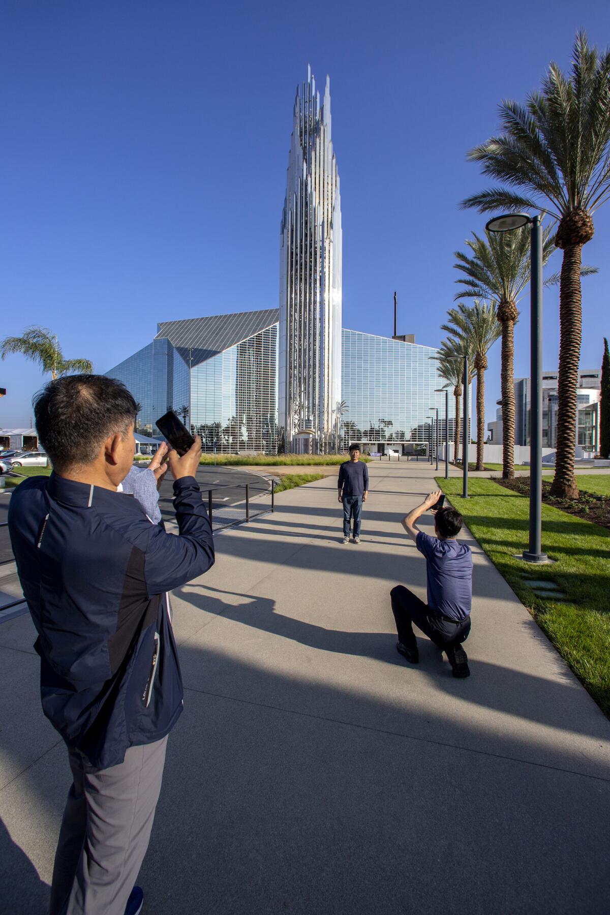 Kim Myeong Ho poses for a photo in front of the Christ Cathedral.