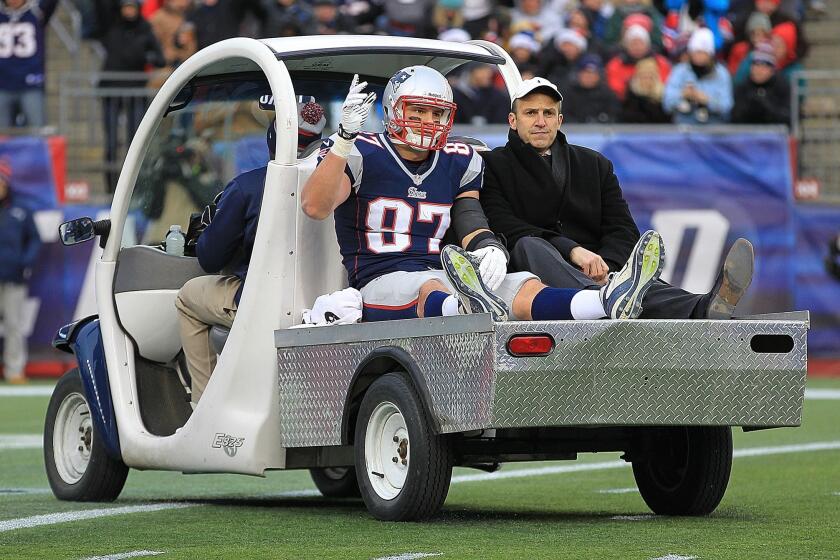 New England tight end Rob Gronkowski reacts to the cheers of fan as he leaves the field with an injury at Gillette Stadium.