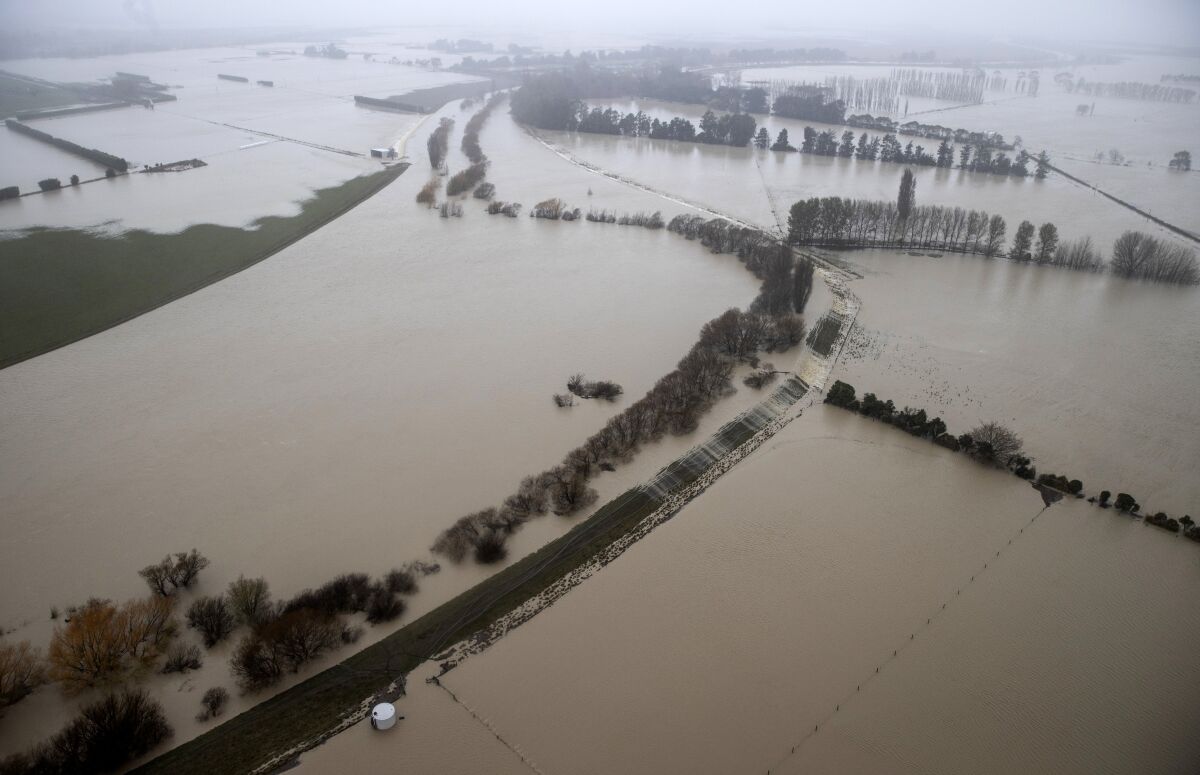 An aerial view of farmland surrounded by flood waters in Canterbury, New Zealand, Monday, May 31, 2021. Several hundred people in New Zealand were evacuated from their homes while others recounted dramatic helicopter rescues as heavy rain caused widespread flooding in the Canterbury region. (George Heard/NZ Herald via AP)