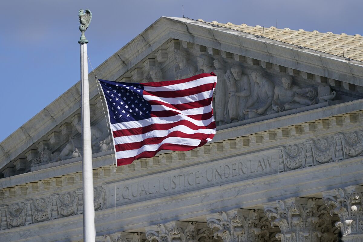 A U.S. flag waves in front of the Supreme Court building